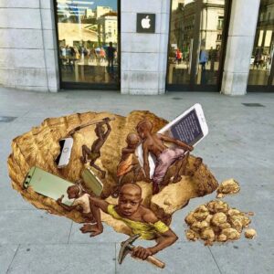Street Art showing a drawing that looks like there is a mining pit in the floor on Child Labour in front of Apple store (Madrid, Spain). IN the pit there are black children in non-european clothes with pickaxes mining iPhones and other Apple merchandies.